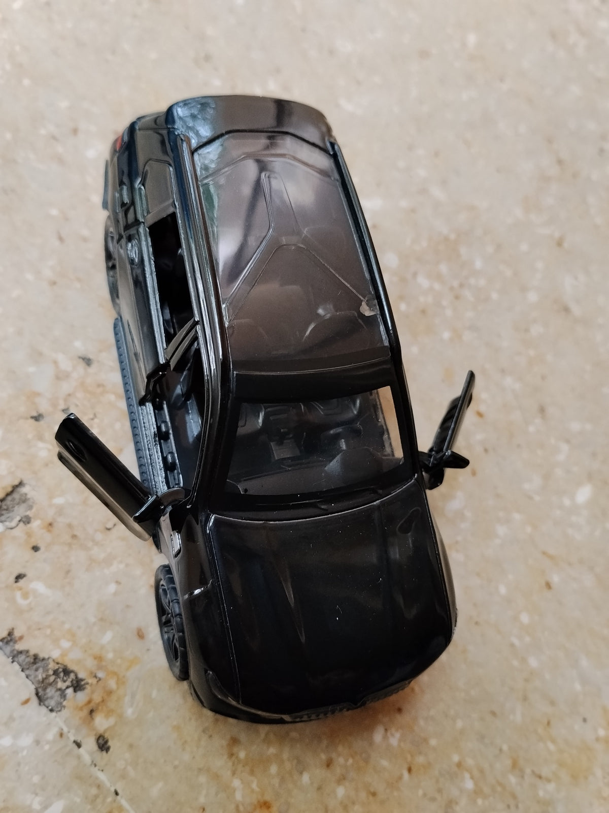 Black BMW die-cast metal toy car with opening front doors