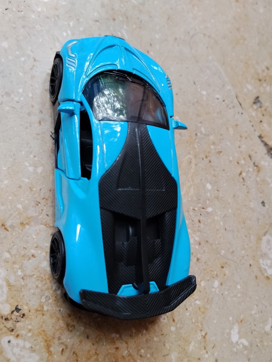 Blue die-cast metal supercar toy rear view
