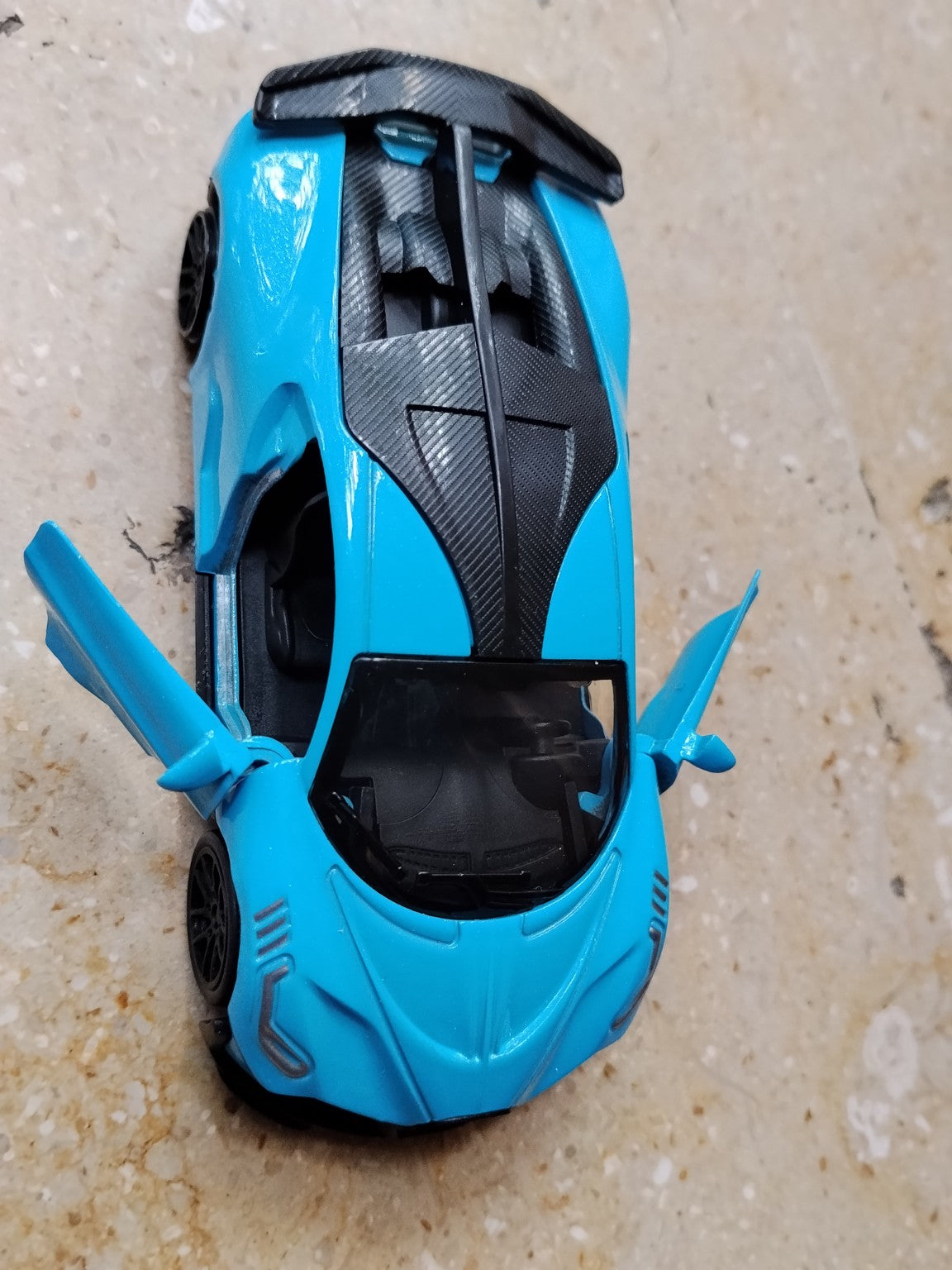 Blue die-cast metal supercar toy top view