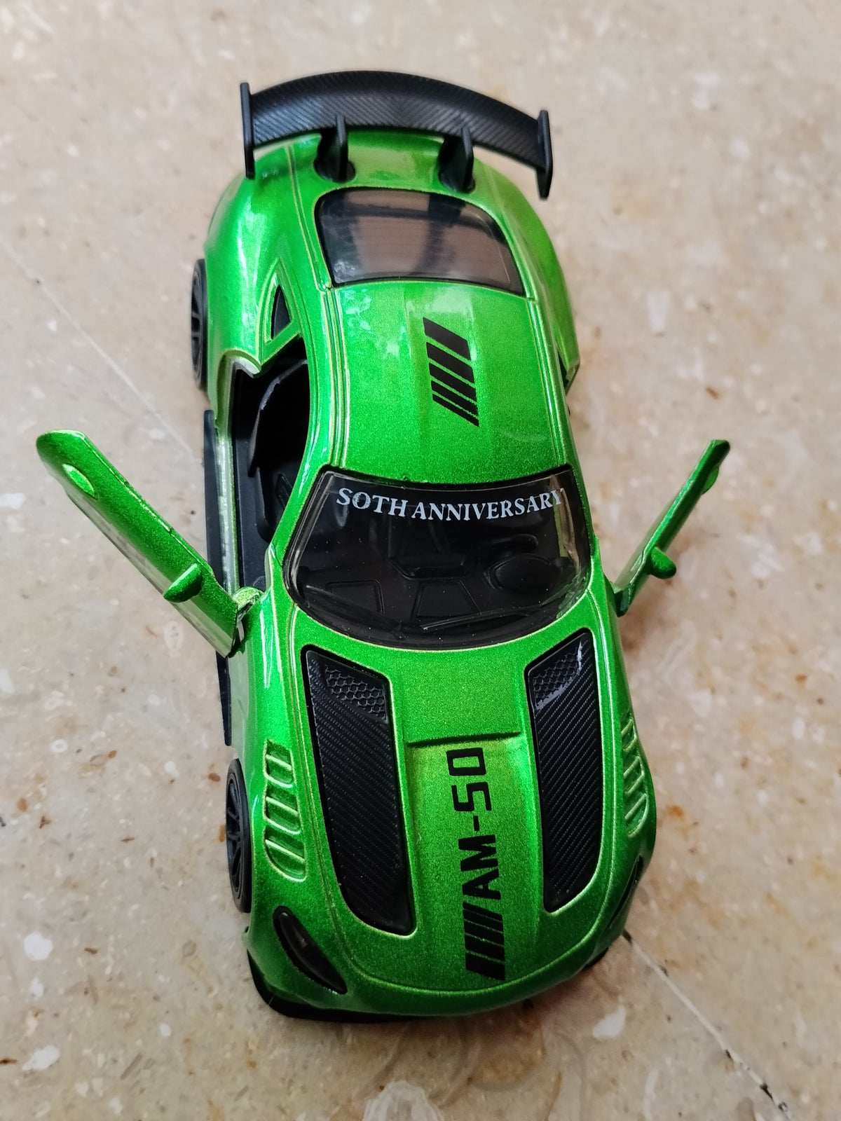 Green die-cast metal sports car with opening front doors