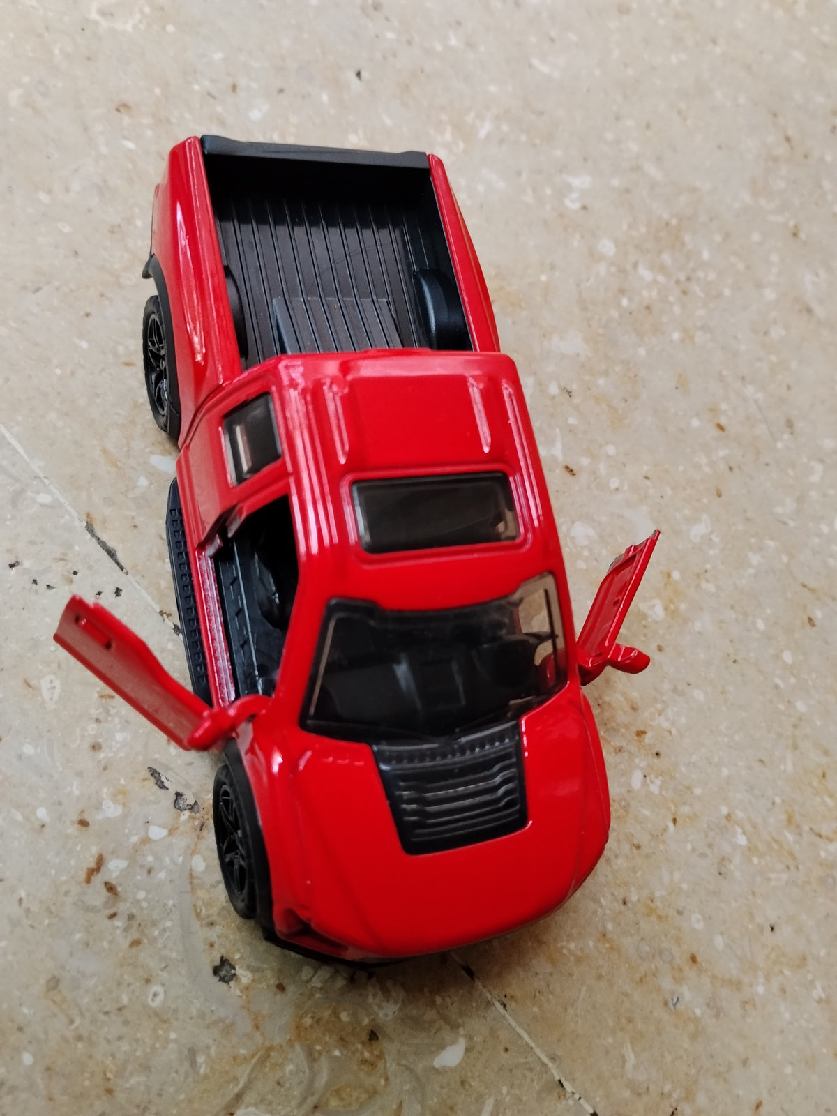 Red die-cast metal pickup truck toy car with opening doors