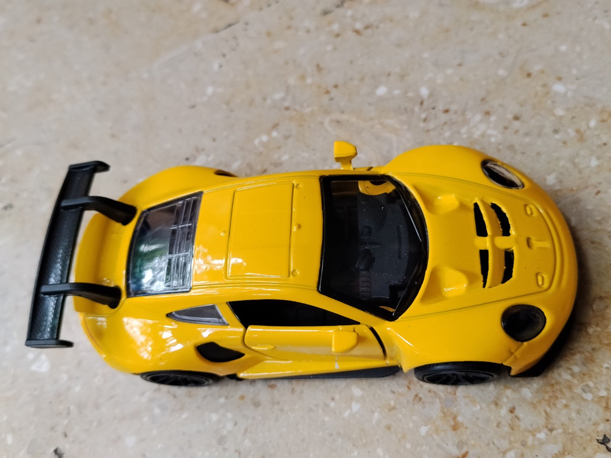 Yellow die-cast metal supercar toy side view